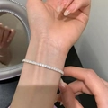 Close-up of sparkling silver tennis bracelet with zircon stones on a woman's wrist - Silver Zirconia Tennis Bracelet (MY35068)