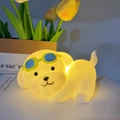 Cute dog-shaped LED night light in soft silicone with blue goggles and warm yellow glow - Sunglasses Dog