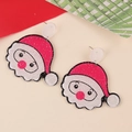 Close-up of glittery red and white Santa Claus Christmas earrings on festive card - Red Nose Santa