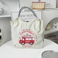 Beige nylon tote bag with red cart embroidery and houndstooth handles in a lifestyle setting - Light Grey Dream Ice Cream Truck