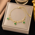 Golden stainless steel chain bracelet with green heart pendants on a jewelry box - Gold Heart Green Zirconia Bracelet