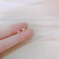 Minimalist 925 silver butterfly stud earrings displayed on a fingertip for size reference - Hollow Butterfly II / Silver