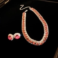 Detail of vintage zircon pearl necklace and red gem earrings on black velvet - Silver Pink