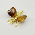 Golden butterfly brooch with tiger eye stone wings and intricate metal textures - Tiger's Eye