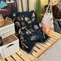 Detail of dark green woven throw blanket with butterfly patterns and fringed edges - XT929-2 Butterfly Forest