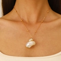 Natural shell pendant necklace with gold beaded chain shown on a female model - Gold Beaded Chain Spiral Conch Necklace