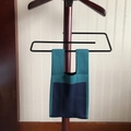 Detail of dark green and navy blue knitted tote bag hanging on a wooden hanger - Patchwork Dark Green