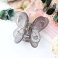 Elegant semi-transparent grey butterfly hair claw clip with hollow wing design and gold spring - Jelly Grey