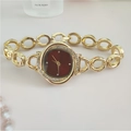 Detailed macro view of a gold flower-shaped watch with red dial and crystal-set bezel - Gold Red Face