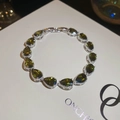 Detail of silver-tone bracelet featuring pear-cut olive green stones and claw settings - Pear-shape Continuous Row Setting Style (10#) / Silver