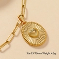 Macro shot of 25x19mm gold heart pendant with radial texture and rope edge detail - Sunburst Heart-111