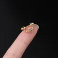 Gold heart tragus earring with clear zircons held on a fingertip for size comparison - Hollow Heart Style (321-5#G)