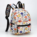 Detail view of a 13 inch kids backpack featuring colorful cartoon fish print on white fabric - White Colorful Fish