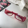Detail of red semi-rimless anti-radiation glasses on laptop with cherry card - Burgundy