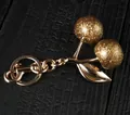 Golden cherry keychain accessory with glitter finish and polished metal hardware - Rich Gold Frosted Cherry with Light Gold
