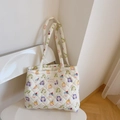 Detailed shot of quilted cotton tote bag featuring colorful cartoon prints and shoulder strap - Cute Girl