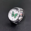 Silver quartz ring watch with white butterfly dial and roman numerals on gray background - Green