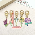 Set of 5 gold enamel flower keychains featuring heart clasps and various floral designs - Multicolor Floral Series (ER764)