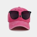 Detail of pink cotton baseball cap featuring integrated black pilot goggles and metal studs - Rose Red
