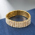 Close-up of four-row elastic gold bracelet with shimmering crystals on blue display - 4 Rows / Gold