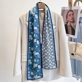 Blue floral and white geometric silk scarf draped on a professional white blazer - Small Blue Buds