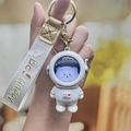 Cartoon astronaut bear keychain in white resin with a purple face and a woven wristband - Glow Astronaut - String Silver Bear
