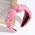 Detail of pink fabric headband with faux pearls, crystal rhinestones and small white flowers - Peach