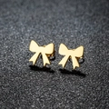 Macro shot of gold bow knot stud earrings with polished finish on black background - 105 Bow / Gold