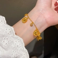 Vintage style gold bracelet with star and flower charms worn on wrist with lace sleeve - Bracelet - Gold - White