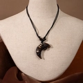 Maori style resin fish hook pendant necklace with brown carved animal design and black cord - Tiger