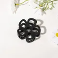 Detail of a matte black flower hair claw clip with a hollow six-petal design on white surface - Hollow Five-Petal Flower - Matte Black