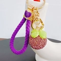 Close-up of creative mangosteen keychain with purple rhinestones and golden heart - Mangosteen with Heart Lanyard