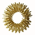 Detailed view of the golden metal spring finger massage ring on a white background - Gold