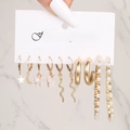 Golden alloy earring set with butterfly and pearl charms on a white jewelry card - Butterfly Snake Star Moon Pearl Style (54730)