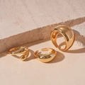 Detailed shot of three chunky gold polished geometric rings on a stone surface - Gold Teardrop (Set of 3)