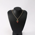 Detail of Christmas wreath pendant necklace with red bow on a black mannequin - Christmas Wreath Style A