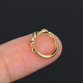 Minimalist gold twisted cartilage piercing hoop shown on fingertip for size reference - Gold (CC094-2)