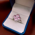 Close-up of pink zircon four-petal flower ring in a blue velvet gift jewelry box - Adjustable Open / Silver-Pink
