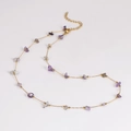 Detailed close-up of gold chain necklace with purple and grey crystal beads and clasp - Necklace