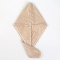 Macro detail of beige thick coral fleece hair towel with resin button fastener - Khaki