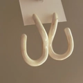 Minimalist beige enamel twisted square earrings with marble pattern on display card - Off-White U-Shape Textured