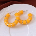 Macro shot of yellow enamel hoop earrings with gold metal stripes on white tray - Steel Pin - Yellow - Gold