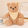 Light brown teddy bear plush toy with yellow checkered bowtie and scarf on a table - Creamy Yellow Bandana / 20cm