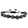 Adjustable woven black nylon bracelet with hexagonal skull hematite beads on white background - Black Skull
