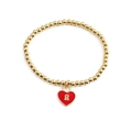 Dettaglio del bracciale con sfere dorate e ciondolo a lucchetto a cuore smaltato rosso - Lucchetto a cuore rosso