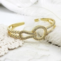 Detail of 18K gold-plated open bangle featuring CZ micro-pave geometric interlocking loops - Style 7 17.7mm Wide