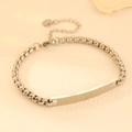 Detail shot of a silver stainless steel box chain bracelet featuring an engravable bar plate - Steel Style (N311)