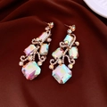 Close-up of gold drop earrings with aurora borealis crystals on dark red silk - Gold / AB Color