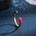 Elegant gold open bangle with pink enamel match-head detail on a dark blue textured surface - Matchstick Design (Open Drip Glue Ring)