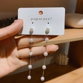 Elegant gold tassel earrings with white pearls and long chain on a jewelry card - Silver Needle Tassel Style (35)